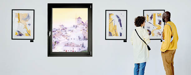 Rear view of young couple visiting art gallery, they standing and watching modern art